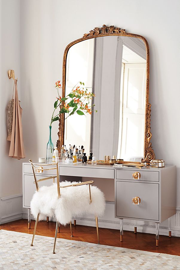 A vintage-style Anthropologie mirror styled with a modern vanity with lucite details.