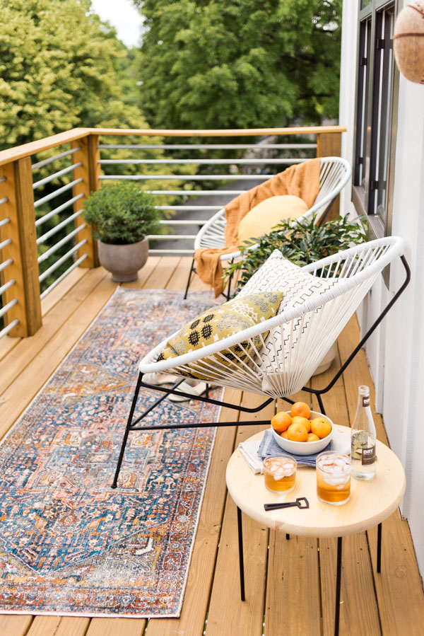 A vintage rug styled on a balcony.
