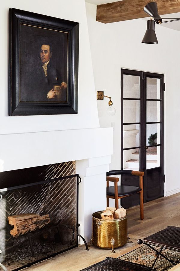 European meets LA style in a living with a cozy fireplace design