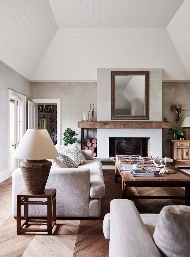 A neutral warm living room with a cozy fireplace design