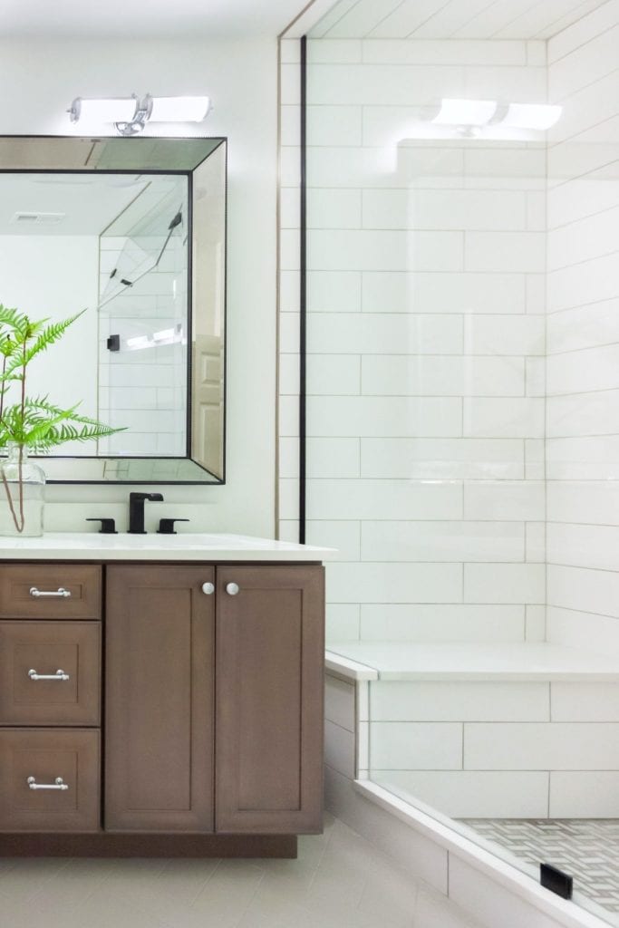 Dark wood vanity and built-in shower bench