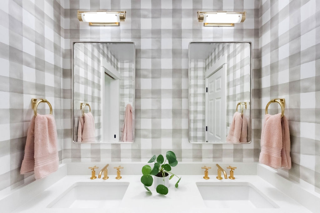 watercolor plaid wallpaper in bathroom with pink towels and gold hardware