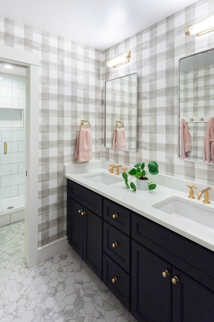 navy cabinets in bathroom with gold knobs
