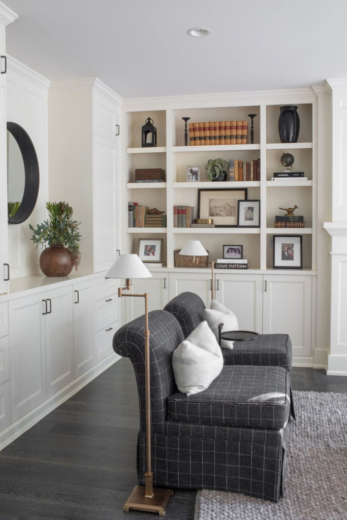white built-in shelving in living room with grey slipper chairs
